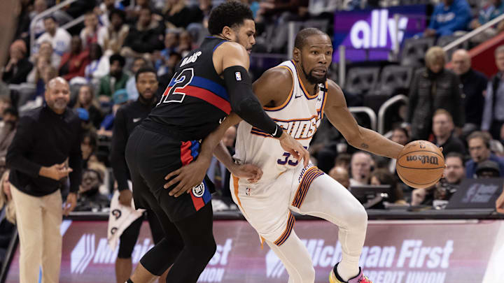 Jan 18, 2025; Detroit, Michigan, USA; Detroit Pistons forward Tobias Harris (12) defends against Phoenix Suns forward Kevin Durant (35) during the fourth quarter at Little Caesars Arena. Mandatory Credit: David Reginek-Imagn Images
