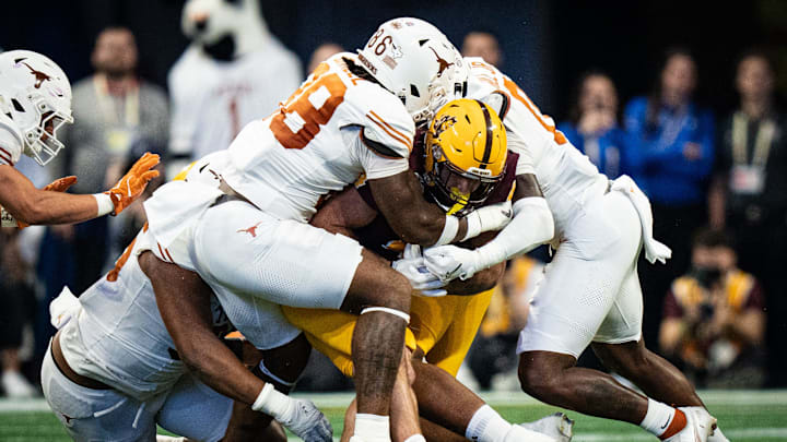 Texas defense, including Texas Longhorns defensive lineman Dorian Black (86) stop Arizona State Sun Devils running back Cam Skattebo (4) in the first quarter as the Texas Longhorns play the Arizona State Sun Devils in the Peach Bowl College Football Playoff quarterfinal at Mercedes-Benz Stadium in Atlanta, Georgia, Jan. 1, 2025.