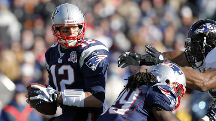 New England Patriots quarterback Tom Brady tries to evade Baltimore Ravens linebacker Ray Lewis. New England Patriots quarterback Tom Brady tries to evade Baltimore Ravens linebacker Ray Lewis.
