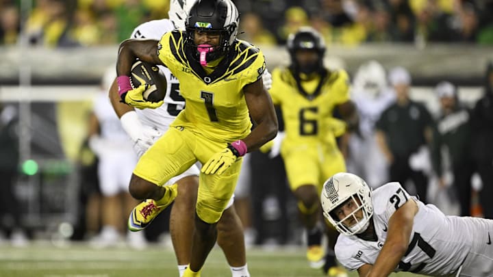 Oct 4, 2024; Eugene, Oregon, USA; Oregon Ducks wide receiver Traeshon Holden (1) breaks a tackle during the first half against Michigan State Spartans linebacker Cal Haladay (27) at Autzen Stadium. Mandatory Credit: Troy Wayrynen-Imagn Images