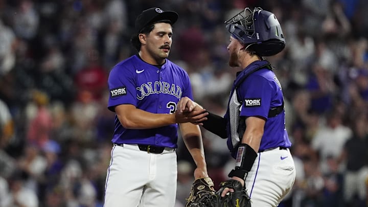 Jul 19, 2025; Denver, Colorado, USA; Colorado Rockies relief pitcher Zach Agnos (36) and catcher Hunter Goodman (15) celebrate the win against the Minnesota Twins at Coors Field. 