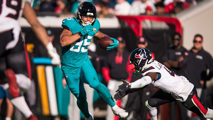 Dec 1, 2024; Jacksonville, Florida, USA; Jacksonville Jaguars tight end Brenton Strange (85) runs after the catch against Houston Texans cornerback Kamari Lassiter (4) in the third quarter  at EverBank Stadium.