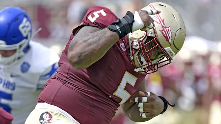 Sep 14, 2024; Tallahassee, Florida, USA; Florida State Seminoles defensive lineman Joshua Farmer (5) celebrates after a defensive stop against the Memphis Tigers during the first half at Doak S. Campbell Stadium. Mandatory Credit: Melina Myers-Imagn Images