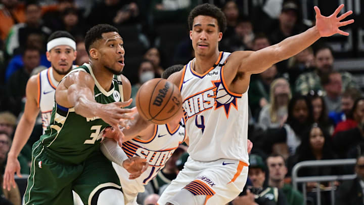 Apr 1, 2025; Milwaukee, Wisconsin, USA;  Milwaukee Bucks forward Giannis Antetokounmpo (34) passes the ball away from Phoenix Suns forward Oso Ighodaro (4) in the second quarter at Fiserv Forum. Mandatory Credit: Benny Sieu-Imagn Images