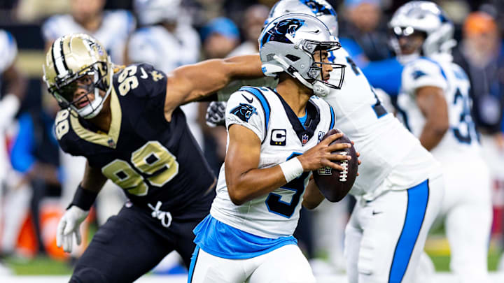 Sep 8, 2024; New Orleans, Louisiana, USA; Carolina Panthers quarterback Bryce Young (9) scrambles to make a pass as New Orleans Saints defensive end Chase Young (99) rushes at him during the second half at Caesars Superdome. Mandatory Credit: Stephen Lew-Imagn Images Sep 8, 2024; New Orleans, Louisiana, USA; Carolina Panthers quarterback Bryce Young (9) scrambles to make a pass as New Orleans Saints defensive end Chase Young (99) rushes at him during the second half at Caesars Superdome. Mandatory Credit: Stephen Lew-Imagn Images