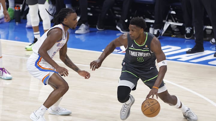 May 20, 2025; Oklahoma City, Oklahoma, USA; Minnesota Timberwolves guard Anthony Edwards (5) dribbles against Oklahoma City Thunder guard Cason Wallace (22) in the first quarter during game one of the western conference finals for the 2025 NBA Playoffs at Paycom Center. Mandatory Credit: Alonzo Adams-Imagn Images