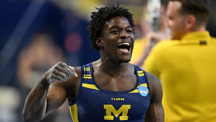 Apr 19, 2025; Ann Arbor, MI, USA;  Michigan gymnast Fred Richard reacts after finishing his parallel bars routine during the NCAA Men’s Gymnastics National Championship Finals at Crisler Center. Mandatory Credit: Lon Horwedel-Imagn Images