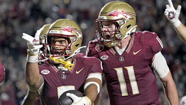 Oct 5, 2024; Tallahassee, Florida, USA; Florida State Seminoles wide receiver Ja'Khi Douglas (0) celebrates with quarterback Brock Glenn (11) after a touchdown against the Clemson Tigers during the second half at Doak S. Campbell Stadium. Mandatory Credit: Melina Myers-Imagn Images