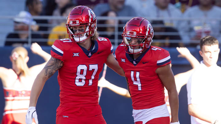 Nov 30, 2024; Tucson, Arizona, USA; Arizona Wildcats wide receiver Tetairoa McMillan (4) celebrates a touchdown with tight end Tyler Powell (87) against the Arizona State Sun Devils during the Territorial Cup at Arizona Stadium. Mandatory Credit: Mark J. Rebilas-Imagn Images