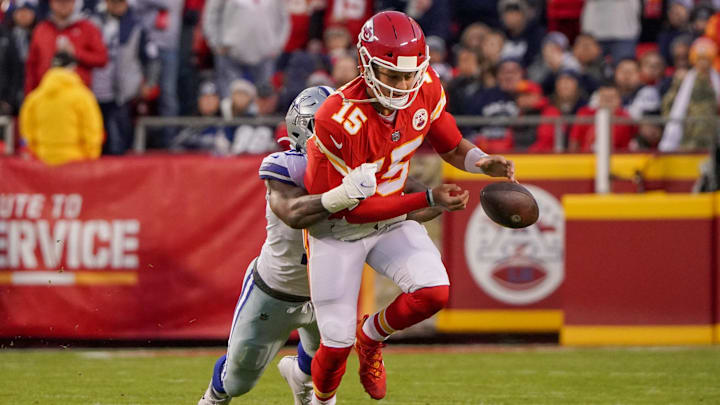 Nov 21, 2021; Kansas City, Missouri, USA; Kansas City Chiefs quarterback Patrick Mahomes (15) fumbles as ht is tackled by Dallas Cowboys outside linebacker Micah Parsons (11) during the first half at GEHA Field at Arrowhead Stadium. Mandatory Credit: Denny Medley-Imagn Images