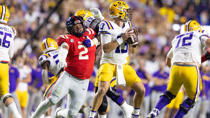 Oct 12, 2024; Baton Rouge, Louisiana, USA; Mississippi Rebels defensive tackle Walter Nolen (2) reaches to knock the ball loose from LSU Tigers quarterback Garrett Nussmeier (13) during the first half at Tiger Stadium. Mandatory Credit: Stephen Lew-Imagn Images Oct 12, 2024; Baton Rouge, Louisiana, USA; Mississippi Rebels defensive tackle Walter Nolen (2) reaches to knock the ball loose from LSU Tigers quarterback Garrett Nussmeier (13) during the first half at Tiger Stadium. Mandatory Credit: Stephen Lew-Imagn Images