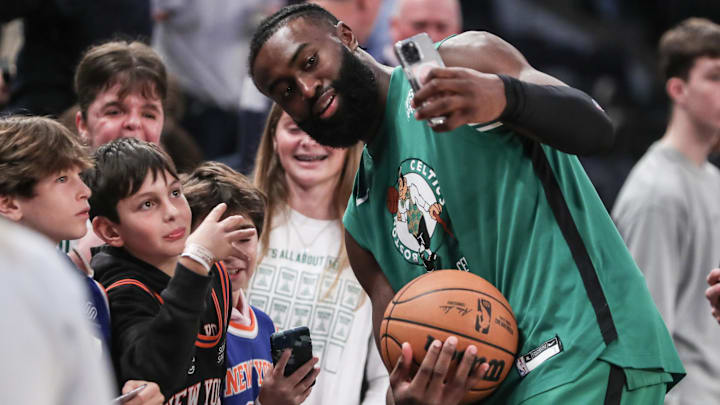 Boston Celtics guard Jaylen Brown (7) poses for photos with fans before the start of the game against the New York Knicks at Madison Square Garden.