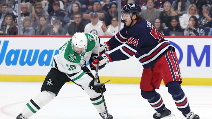 Nov 9, 2024; Winnipeg, Manitoba, CAN; Dallas Stars center Colin Blackwell (15) is checked by Winnipeg Jets defenseman Dylan Samberg (54) in the first period at Canada Life Centre. Mandatory Credit: James Carey Lauder-Imagn Images