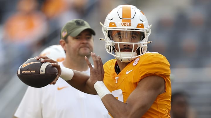 Nov 25, 2023; Knoxville, Tennessee, USA; Tennessee Volunteers quarterback Nico Iamaleava (8) warms up as head coach Josh Heupel looks on before the game against the Vanderbilt Commodores at Neyland Stadium. Mandatory Credit: Randy Sartin-Imagn Images