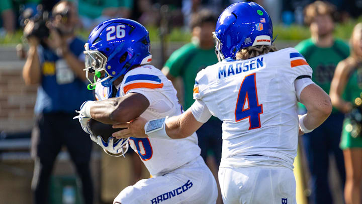 Boise State quarterback Maddux Madsen hands off to Sire Gaines. Boise State quarterback Maddux Madsen hands off to Sire Gaines.