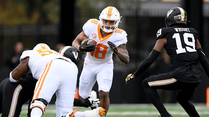 Nov 30, 2024; Nashville, Tennessee, USA; Tennessee Volunteers running back DeSean Bishop (18) hurdles over the tackle of Vanderbilt Commodores safety De'Rickey Wright (19) during the second half at FirstBank Stadium. Mandatory Credit: Steve Roberts-Imagn Images Nov 30, 2024; Nashville, Tennessee, USA; Tennessee Volunteers running back DeSean Bishop (18) hurdles over the tackle of Vanderbilt Commodores safety De'Rickey Wright (19) during the second half at FirstBank Stadium. Mandatory Credit: Steve Roberts-Imagn Images