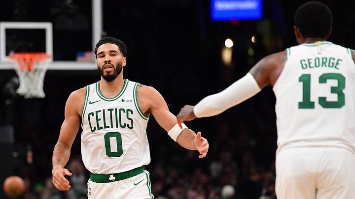 Boston Celtics forward Jayson Tatum (0) is congratulated by forward Paul George (13) after making a basket