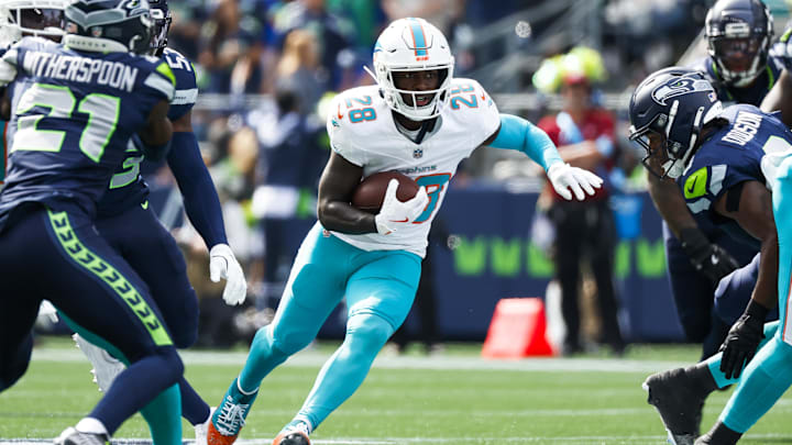 Sep 22, 2024; Seattle, Washington, USA; Miami Dolphins running back DeVon Achane (28) rushes against the Seattle Seahawks during the first quarter at Lumen Field. Mandatory Credit: Joe Nicholson-Imagn Images