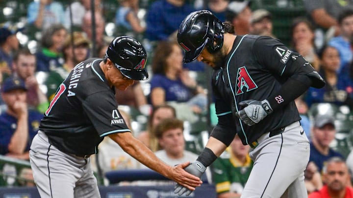 Sep 22, 2024; Milwaukee, Wisconsin, USA; Arizona Diamondbacks third baseman Eugenio Suarez (28) greets third base coach Tony Perezchica after hitting a solo home run in the third inning against the Milwaukee Brewers at American Family Field. Mandatory Credit: Benny Sieu-Imagn Images Sep 22, 2024; Milwaukee, Wisconsin, USA; Arizona Diamondbacks third baseman Eugenio Suarez (28) greets third base coach Tony Perezchica after hitting a solo home run in the third inning against the Milwaukee Brewers at American Family Field. Mandatory Credit: Benny Sieu-Imagn Images
