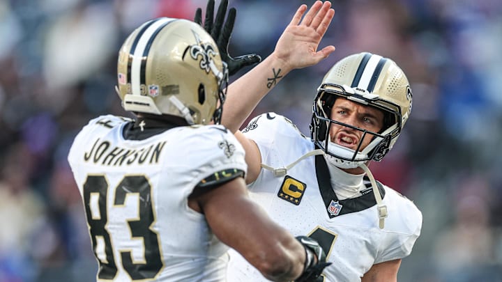 Dec 8, 2024; East Rutherford, New Jersey, USA; New Orleans Saints tight end Juwan Johnson (83) celebrates his touchdown reception from quarterback Derek Carr (4) during the second half against the New York Giants at MetLife Stadium. Mandatory Credit: Vincent Carchietta-Imagn Images
