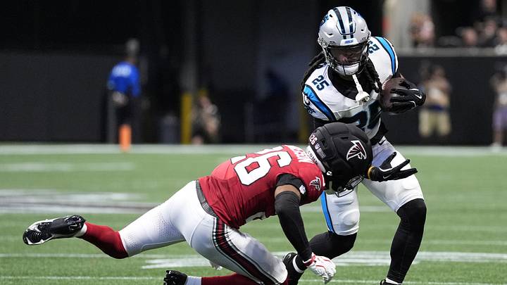 Carolina Panthers running back Jonathon Brooks (25) rushes and is tackled by Atlanta Falcons cornerback C.J. Henderson Carolina Panthers running back Jonathon Brooks (25) rushes and is tackled by Atlanta Falcons cornerback C.J. Henderson