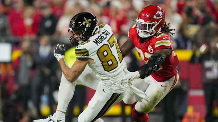 Oct 7, 2024; Kansas City, Missouri, USA; New Orleans Saints tight end Foster Moreau (87) catches a pass against Kansas City Chiefs linebacker Nick Bolton (32) during the second half at GEHA Field at Arrowhead Stadium. Mandatory Credit: Jay Biggerstaff-Imagn Images Oct 7, 2024; Kansas City, Missouri, USA; New Orleans Saints tight end Foster Moreau (87) catches a pass against Kansas City Chiefs linebacker Nick Bolton (32) during the second half at GEHA Field at Arrowhead Stadium. Mandatory Credit: Jay Biggerstaff-Imagn Images