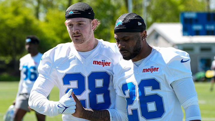 Detroit Lions safety Dan Jackson (28), left, shakes hands with cornerback Duke Shelley (26) after rookie minicamp practice