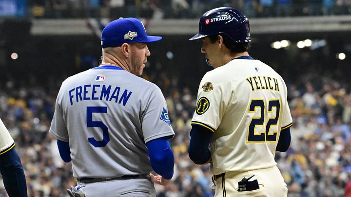 Oct 13, 2025; Milwaukee, Wisconsin, USA; Milwaukee Brewers designated hitter Christian Yelich (22) talks with Los Angeles Dodgers first baseman Freddie Freeman (5) during the ninth inning during game one of the NLCS round for the 2025 MLB playoffs at American Family Field. Mandatory Credit: Benny Sieu-Imagn Images Oct 13, 2025; Milwaukee, Wisconsin, USA; Milwaukee Brewers designated hitter Christian Yelich (22) talks with Los Angeles Dodgers first baseman Freddie Freeman (5) during the ninth inning during game one of the NLCS round for the 2025 MLB playoffs at American Family Field. Mandatory Credit: Benny Sieu-Imagn Images