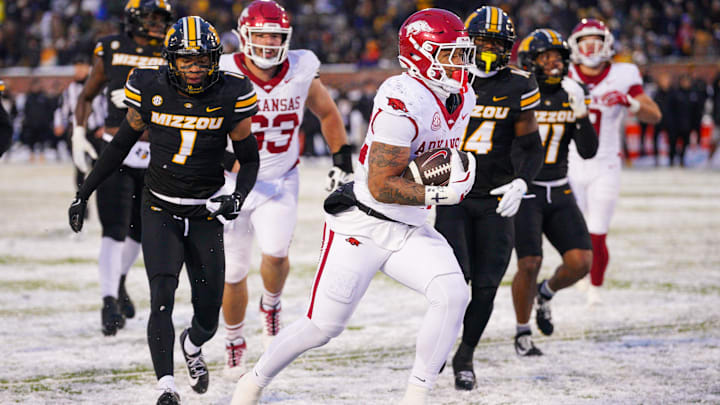 Nov 30, 2024; Columbia, Missouri, USA; Arkansas Razorbacks running back Ja'Quinden Jackson (22) scores a touchdown as Missouri Tigers safety Marvin Burks Jr. (1) looks on during the second half at Faurot Field at Memorial Stadium. Mandatory Credit: Denny Medley-Imagn Images Nov 30, 2024; Columbia, Missouri, USA; Arkansas Razorbacks running back Ja'Quinden Jackson (22) scores a touchdown as Missouri Tigers safety Marvin Burks Jr. (1) looks on during the second half at Faurot Field at Memorial Stadium. Mandatory Credit: Denny Medley-Imagn Images