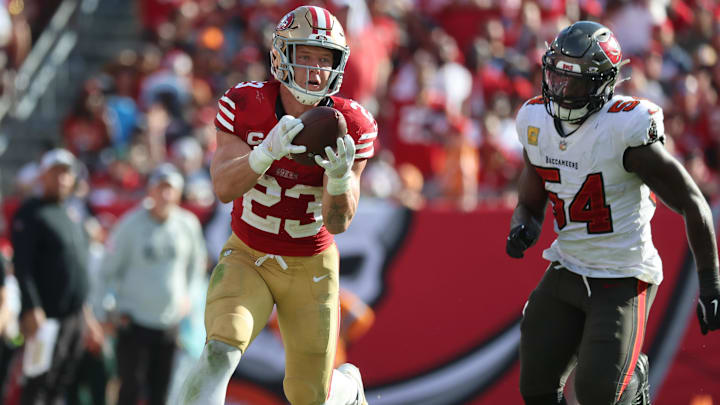 Nov 10, 2024; Tampa, Florida, USA; San Francisco 49ers running back Christian McCaffrey (23) catches the ball over Tampa Bay Buccaneers linebacker Lavonte David (54) during the second half at Raymond James Stadium. Mandatory Credit: Kim Klement Neitzel-Imagn Images