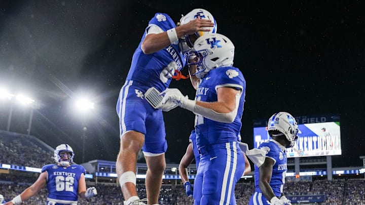 Kentucky Wildcats quarterback Cutter Boley (8), left, celebrates his touchdown pass to Kentucky Wildcats tight end Willie Rodriguez (81) in the second quarter as the Wildcats are rolling in the football game against Eastern Michigan at Kroger Field in Lexington, Kentucky Saturday, Sept. 13, 2025.
