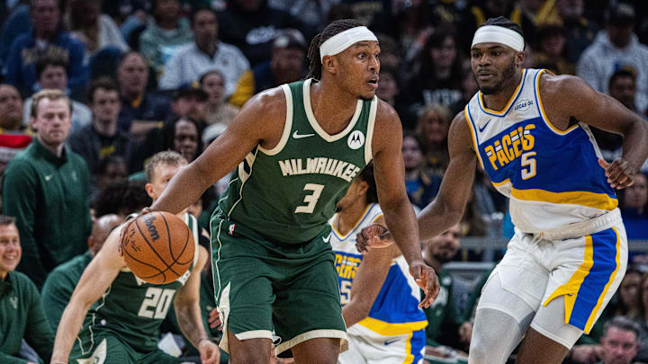 Dec 23, 2025; Indianapolis, Indiana, USA;  Milwaukee Bucks center/forward Myles Turner (3) dribbles the ball while Indiana Pacers forward Jarace Walker (5) defends in the first half at Gainbridge Fieldhouse. Mandatory Credit: Trevor Ruszkowski-Imagn Images