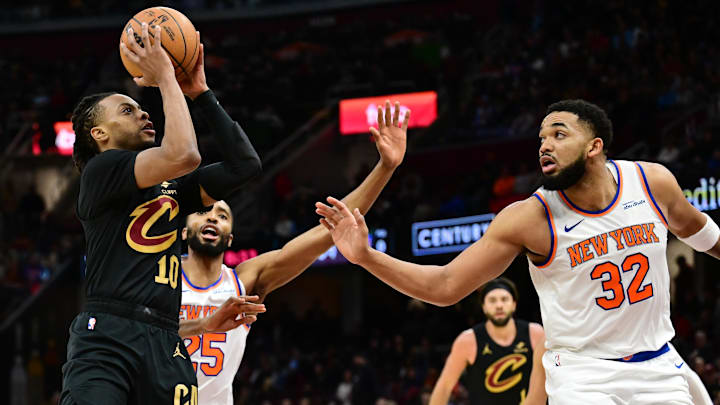 Feb 21, 2025; Cleveland, Ohio, USA;  Cleveland Cavaliers guard Darius Garland (10) shoots as New York Knicks center Karl-Anthony Towns (32) defends during the second half at Rocket Arena. Mandatory Credit: Ken Blaze-Imagn Images
