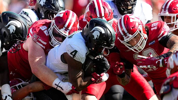 Oct 3, 2026; Madison, Wisconsin, USA;  Michigan State Spartans running back Jaziun Patterson (4) is tackled while carrying the football during the fourth quarter against the Wisconsin Badgers at Camp Randall Stadium. Mandatory Credit: Jeff Hanisch-Imagn Images