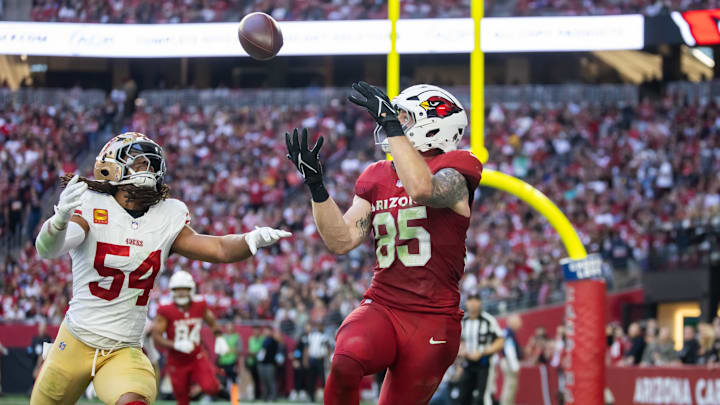 Jan 5, 2025; Glendale, Arizona, USA; Arizona Cardinals tight end Trey McBride (85) catches a touchdown pass against San Francisco 49ers linebacker Fred Warner (54) in the first half at State Farm Stadium. Mandatory Credit: Mark J. Rebilas-Imagn Images
