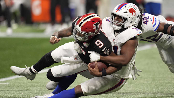 Atlanta Falcons quarterback Michael Penix Jr. (9) is sacked by Buffalo Bills defensive tackle Ed Oliver (91) during the second half of a game at Mercedes-Benz Stadium.
