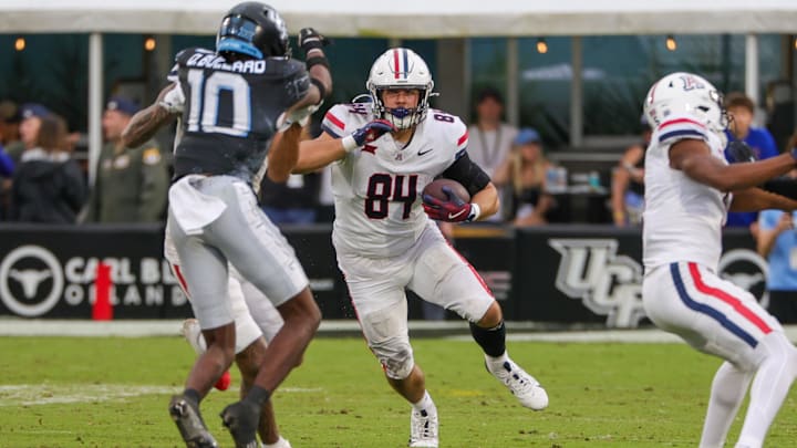Nov 2, 2024; Orlando, Florida, USA; Arizona Wildcats tight end Sam Olson (84) runs the ball against the UCF Knights during the second half at FBC Mortgage Stadium. Mandatory Credit: Mike Watters-Imagn Images Nov 2, 2024; Orlando, Florida, USA; Arizona Wildcats tight end Sam Olson (84) runs the ball against the UCF Knights during the second half at FBC Mortgage Stadium. Mandatory Credit: Mike Watters-Imagn Images
