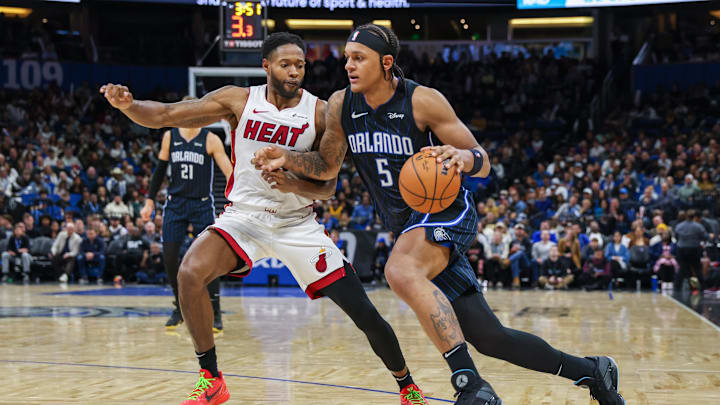 Jan 21, 2024; Orlando, Florida, USA; Orlando Magic forward Paolo Banchero (5) drives to the basket in front of Miami Heat forward Haywood Highsmith (24) during the second half at Amway Center. Mandatory Credit: Mike Watters-Imagn Images