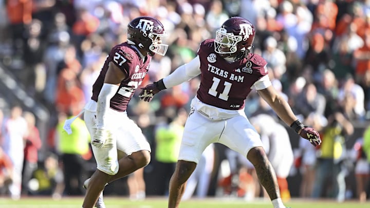 Dec 20, 2025; College Station, TX, USA; Texas A&M Aggies linebacker Daymion Sanford (27) reacts with defensive tackle Tyler Onyedim (11) after recovering a fumble against the Miami Hurricanes during the second half of the first round game of the CFP National Playoff at Kyle Field. Mandatory Credit: Maria Lysaker-Imagn Images
