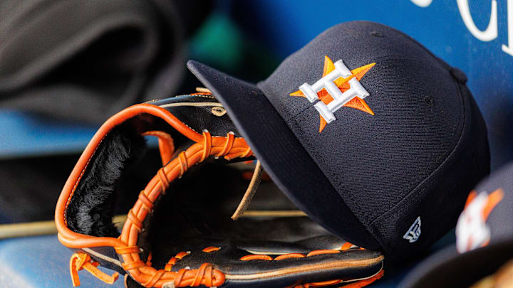 Apr 27, 2025; Kansas City, Missouri, USA; Houston Astros hat and glove in the dugout during the second inning against the Kansas City Royals at Kauffman Stadium. Mandatory Credit: William Purnell-Imagn Images