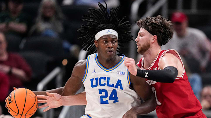 UCLA Bruins forward William Kyle III (24) rushes up the court against Wisconsin Badgers forward Carter Gilmore (7) on Friday, March 14, 2025, during the third round of the men's Big Ten tournament at Gainbridge Fieldhouse in Indianapolis. UCLA Bruins forward William Kyle III (24) rushes up the court against Wisconsin Badgers forward Carter Gilmore (7) on Friday, March 14, 2025, during the third round of the men's Big Ten tournament at Gainbridge Fieldhouse in Indianapolis.