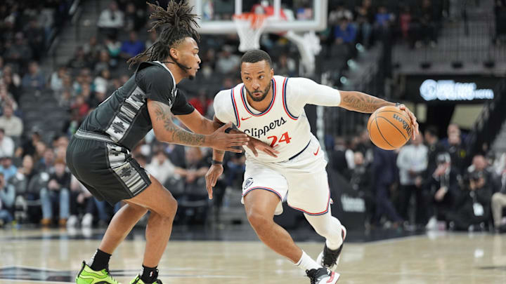 Jan 29, 2025; San Antonio, Texas, USA;  LA Clippers guard Norman Powell (24) dribbles against San Antonio Spurs guard Stephon Castle (5) in the first half at Frost Bank Center. Mandatory Credit: Daniel Dunn-Imagn Images
