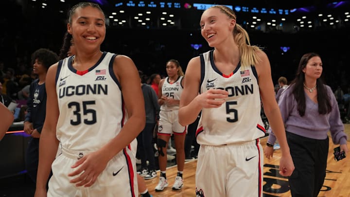 Huskies guard Azzi Fudd (35) and Connecticut Huskies guard Paige Bueckers (5) celebrate after the game against the Louisville Cardinals at Barclays Center.