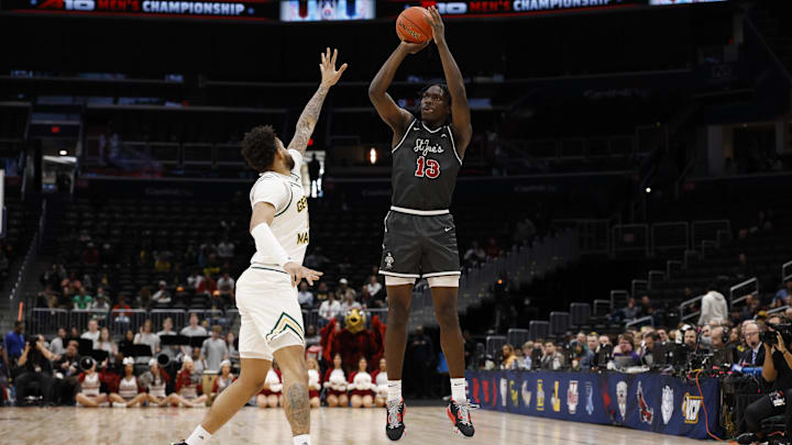 Mar 15, 2025; Washington, D.C., USA; Saint Joseph's Hawks forward Rasheer Fleming (13) shoots the ball over George Mason University forward Shawn Simmons II (10) in the first half at Capital One Arena.