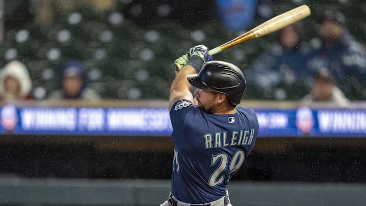 Apr 27, 2026; Minneapolis, Minnesota, USA; Seattle Mariners designated hitter Cal Raleigh (29) hits a two run home run against the Minnesota Twins in the eighth inning at Target Field. Mandatory Credit: Jesse Johnson-Imagn Images
