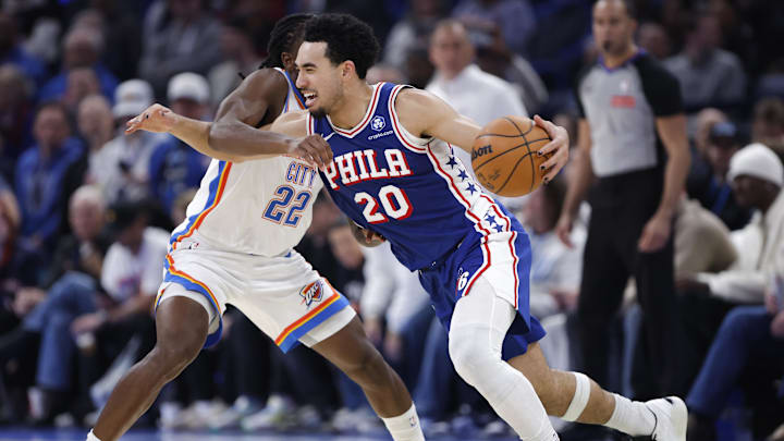 Dec 28, 2025; Oklahoma City, Oklahoma, USA; Philadelphia 76ers guard Jared McCain (20) drives against Oklahoma City Thunder guard Cason Wallace (22) during the second half at Paycom Center. Mandatory Credit: Alonzo Adams-Imagn Images