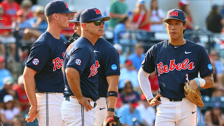 Jun 1, 2025; Oxford, MS, USA; Mississippi Rebels head coach Mike Bianco (left) makes a pitching change during the ninth inning against the Georgia Tech Yellowjackets. Mandatory Credit: Petre Thomas-Imagn Images Jun 1, 2025; Oxford, MS, USA; Mississippi Rebels head coach Mike Bianco (left) makes a pitching change during the ninth inning against the Georgia Tech Yellowjackets. Mandatory Credit: Petre Thomas-Imagn Images