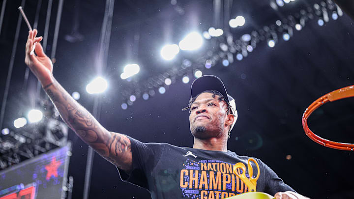 Alijah Martin helps cut down the net after the Florida Gators' win in the national championship. Alijah Martin helps cut down the net after the Florida Gators' win in the national championship.