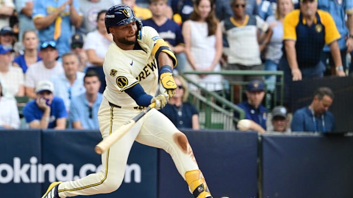 Oct 4, 2025; Milwaukee, Wisconsin, USA; Milwaukee Brewers left fielder Jackson Chourio (11) hits an RBI single against the Chicago Cubs during the first inning of game one of the NLDS round for the 2025 MLB playoffs at American Family Field. Mandatory Credit: Benny Sieu-Imagn Images