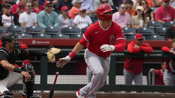 Mar 19, 2023; Scottsdale, Arizona, USA; Los Angeles Angels first baseman Jake Lamb (18) hits a single against the San Francisco Giants in the first inning at Scottsdale Stadium.